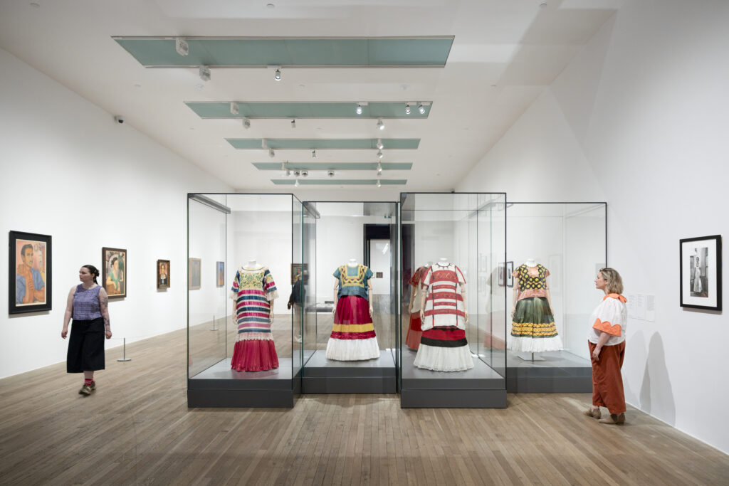 Traditional Tehuana dresses displayed in Frida: The Making of an Icon at Tate Modern, highlighting the influence of Mexican culture on Frida Kahlo.