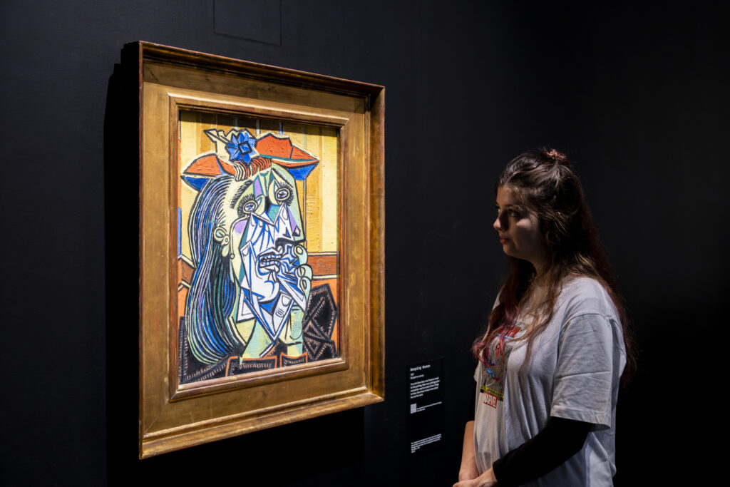 Woman observing Weeping Woman (1937) by Pablo Picasso at Tate Modern during the Theatre Picasso exhibition, autumn 2025