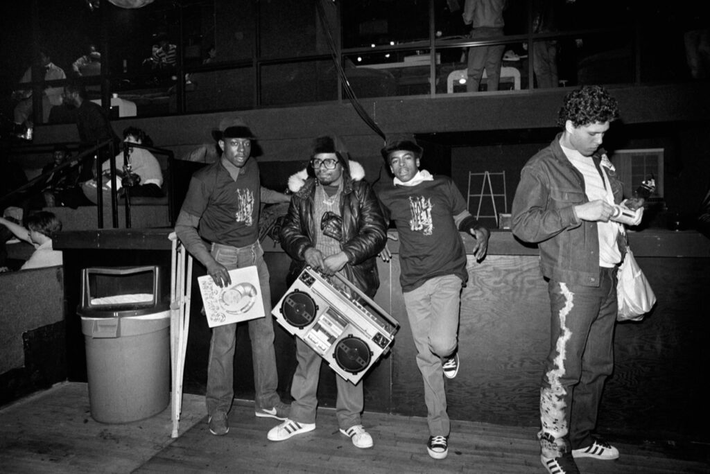 Youths in a club with a boombox, early hip-hop scene in New York — photograph by Sophie Bramly, Urban Photo 2025