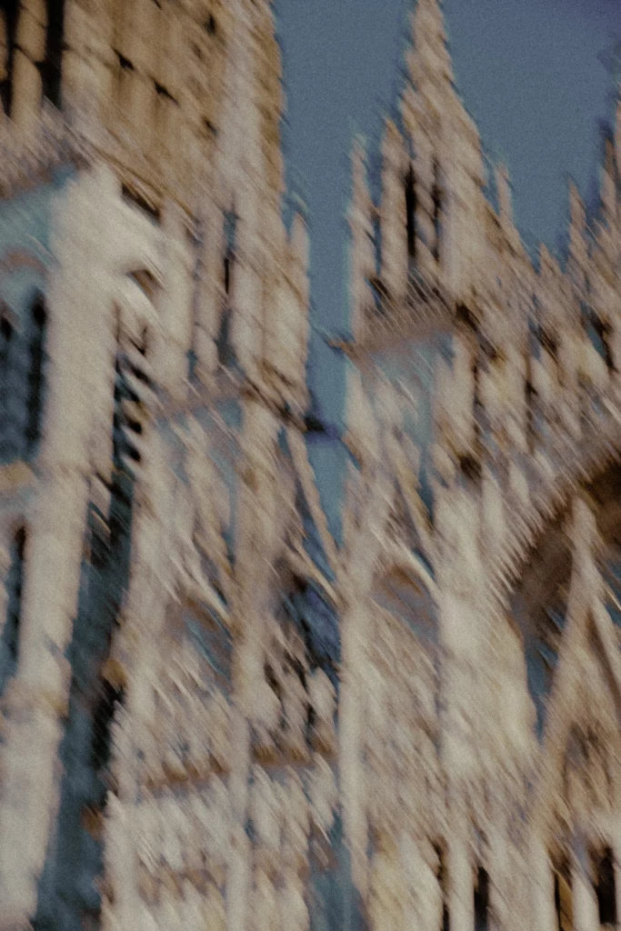 Cathedral façade vibrating in motion blur, impressionist reference in Normandy.
