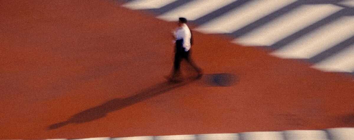 Piéton flou traversant un carrefour rouge avec zébrures blanches, effet de filé à Séoul. Art mag