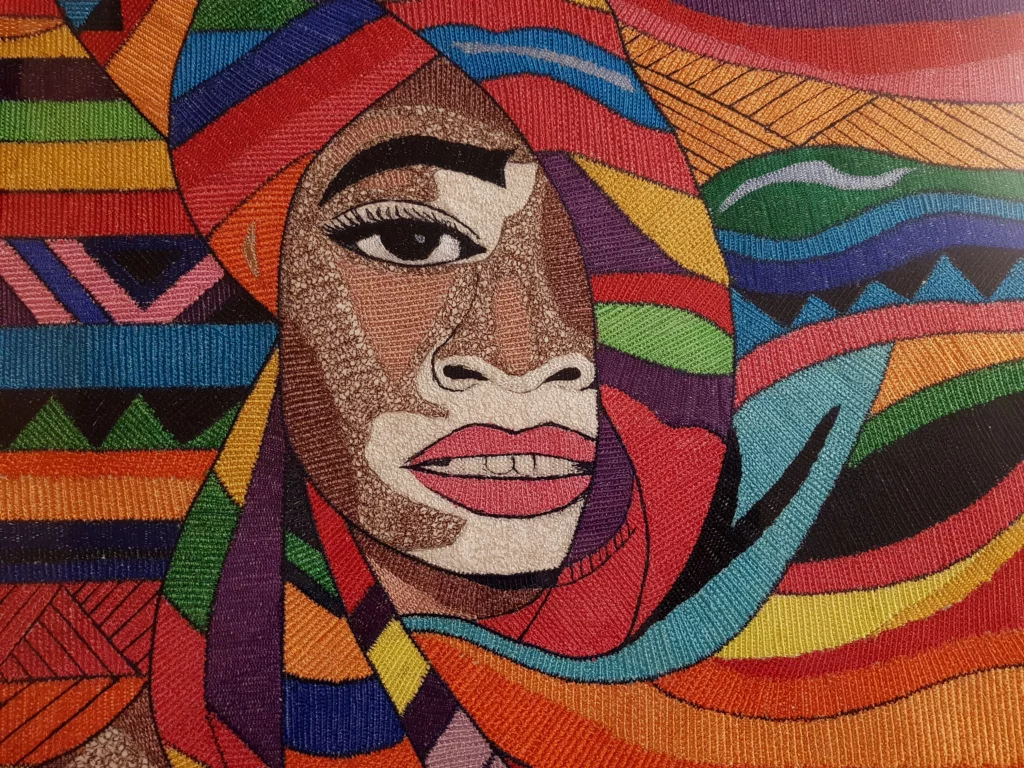 The Beauty Behind Illness – Textile portrait by Willfreed celebrating skin diversity and inner strength through the representation of vitiligo.