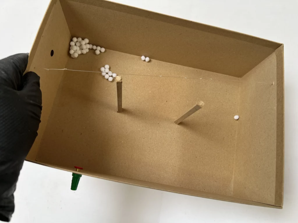 Cardboard model for Joëlle Tuerlinckx’s installation La Première Fois, featuring miniature elements used to explore the layout of the exhibition room at KANAL–Centre Pompidou.